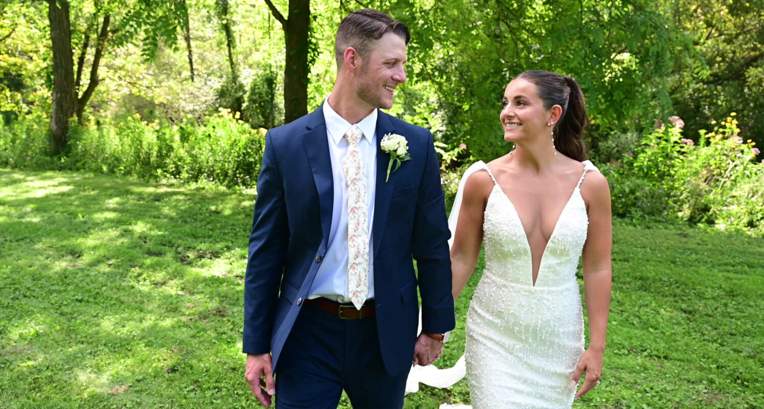 bride and groom walking holding hands